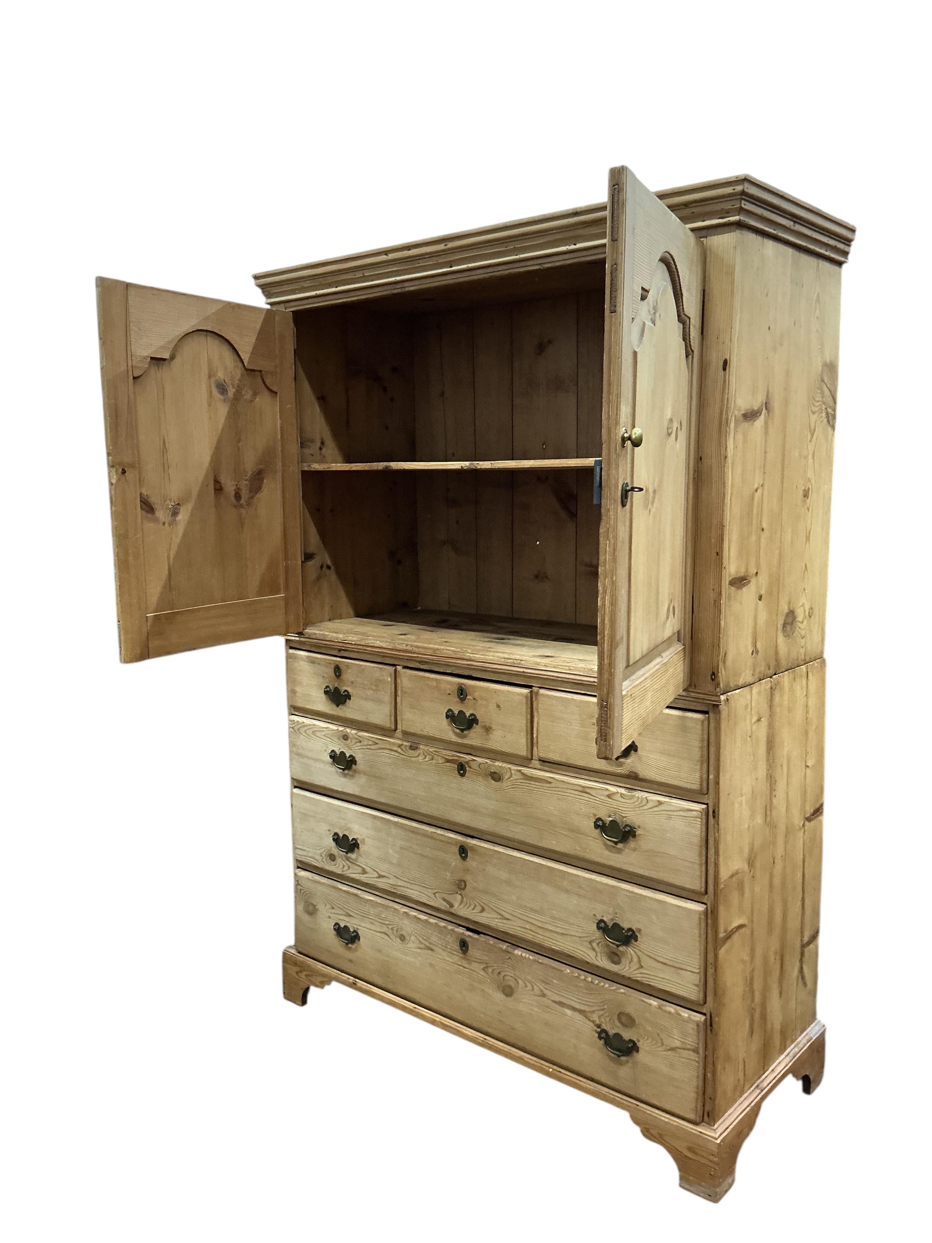 An early 19th century pine two part press cupboard, width 125cm, depth 54cm, height 191cm